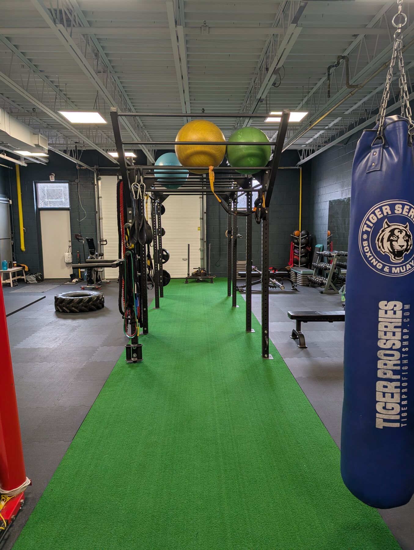 Heavy bags and medicine balls along the OBFT training floor